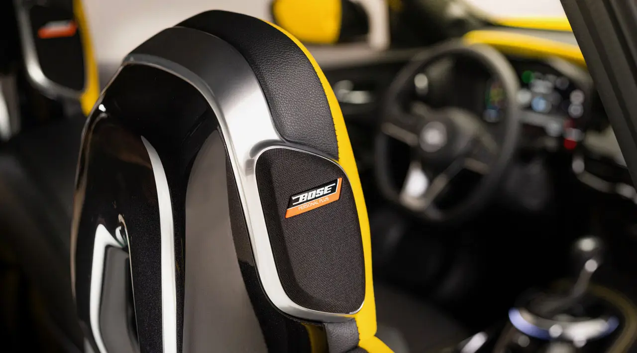 Cockpit eines Nissan JUKE mit gelben Ziernähten und integriertem BOSE-Lautsprecher im Sitz.